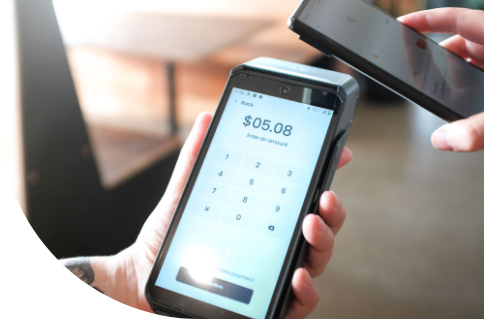 A customer tapping a phone on a Zeller terminal.
